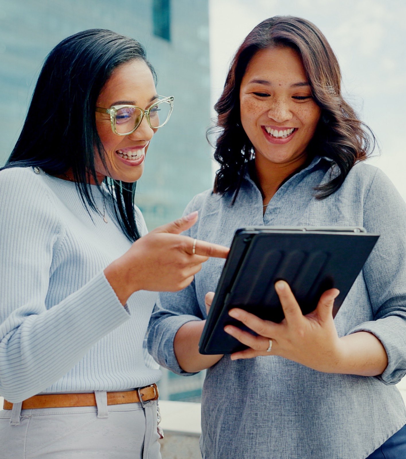 Two professionals reviewing information together on a tablet